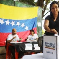 RIO DE JANEIRO, BRAZIL - JULY 16: An expatriate Venezuelan casts her ballot during an unofficial referendum, or plebiscite, held by Venezuela's opposition against Venezuela's President Nicolas Maduro's government on July 16, 2017 in Rio de Janeiro, Brazil. Voting was conducted across 2,000 polling centers in Venezuela and in more than 80 countries around the world amidst a severe crisis in Venezuela. (Photo by Mario Tama/Getty Images)