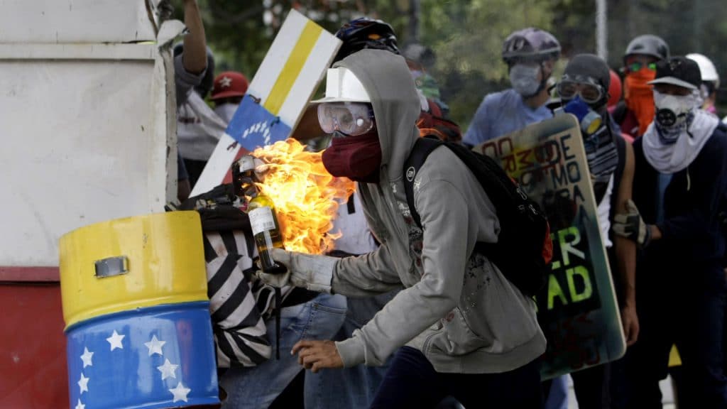 A demonstrators readies a gasoline bomb as he prepares to throw it at the police during clashes between authorities and anti-government demonstrators in Caracas, Venezuela, Wednesday, June 7, 2017. The protest movement has claimed more than 60 lives as it enters its third month. (AP Photo/Fernando Llano)