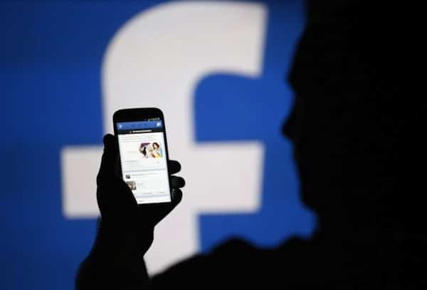 | A man is silhouetted against a video screen with an Facebook logo as he poses with an Samsung S4 smartphone in this photo illustration taken in the central Bosnian town of Zenica August 14 2013 REUTERSDado RuvicFile Photo | MR Online