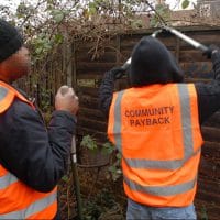 Two men sentenced to perform unpaid community work wearing tabards emblazoned with 'Community Payback' to make their punishment visible
