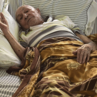 93-year-old World War II veteran Antonio Morales rests in a single-story concrete home with no running water, in Corozal, Puerto Rico. Morales is one of thousands still waiting for water and power as the six-month anniversary of Hurricane Maria approaches