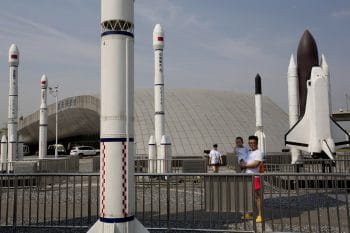 A man holds a child as they visit a park with replicas of foreign and domestic space vehicles displayed in Beijing, China, June 26, 2016. (AP/Ng Han Guan)