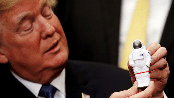 | President Donald Trump holds a toy astronaut as he participates in a signing ceremony for Space Policy Directive at the White House Reuters Photo | MR Online