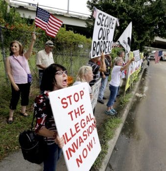 Barbie Miller, left, yells as she joins demonstrators outside the Mexican Consulate, July 18, 2014, in Houston, Texas. David J. Phillip | AP