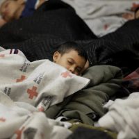 Child detainees sleep in a holding cell at a U.S. Customs and Border Protection processing facility, on June 18, 2014, in Brownsville,Texas.