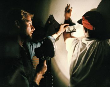 A U.S. marshal, left, looking for a suspect, shows a mug shot to a man found allegedly using drugs in a crackhouse, according to police, in Washington, D.C., on July 18, 1989. The police raid was part of President George H.W. Bush’s war on drugs. Photo: J. Scott Applewhite/AP
