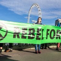 | Extinction Rebellion activists hold a banner reading Rebel for life Photo Credit Thomas Katan | MR Online