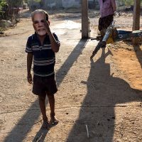 A boy in a Modi mask