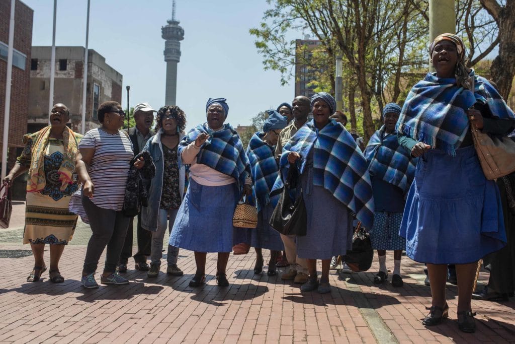 Residents of the Lesetlheng village community from the North West celebrating outside the Constitutional Court