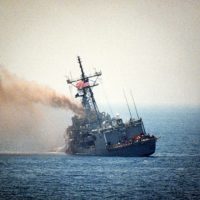USS STARK (FFG-31) listing to port after being hit by two Iraqi Exocet missiles
