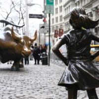 The Fearless Girl statue looks up the iconic Wall Street Charging Bull sculpture in New York on March 29, 2018. (Volkan Furuncu/Anadolu Agency/Getty Images)