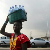 A man sells bottled water in Lagos, Nigeria PHOTO- Reuters:Akintunde Akinleye
