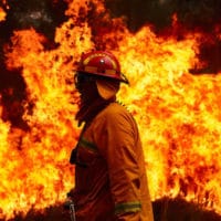 A firefighting crew works to control a blaze in Sydney, Australia in November. BRETT HEMMINGS:GETTY IMAGES