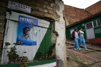 | Neighbors pass by campaign poster of presidential candidate Gustavo Petro at quotBolivar 83quot community in the town of Zipaquira north of Bogota Colombia Saturday June 16 2018 Petro a former leftist rebel and exBogota mayor will face Ivan Duque a former senator and protege of former President Alvaro Uribe in a runoff election on Sunday AP PhotoMartin Mejia | MR Online
