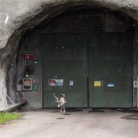 “A reindeer stands in silent protest in front of a hydro power plant” on Indigenous Sámi land in northern Scandinavia. Image: Tobias Herrmann CC BY-NC 2.0