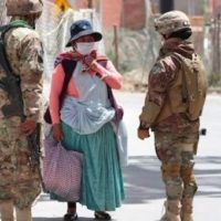 Soldiers question an indigenous woman on the way to buy food. Photo: TeleSUR