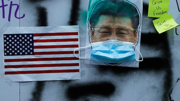 | Pictures of US national flag and Chinese President Xi Jinping with mask made by protestors are displayed in central district of Hong Kongs business district Oct 14 2019 Kin Cheung | AP | MR Online