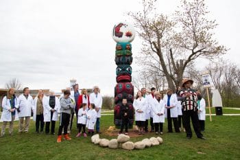 Freddie Lane of the Lummi Nation leads a totem pole blessing ceremony at the opening of “Kwel’ Hoy: Many Struggles, One Front,” an exhibition by the House of Tears Carvers of the Lummi Nation and The Natural History Museum at The Watershed Center, a science education and advocacy center outside of Princeton, New Jersey in 2018. Connecting the science community’s efforts to protect the local watershed from the proposed PennEast Pipeline to the nearby Ramapough Lenape Nation’s struggle to stop the Pilgrim Pipeline, and the Lummi’s struggles to protect the waters of the Pacific Northwest from oil tankers and pipelines, the exhibition was one stop of a cross-country tour, an evolving museum exhibition and series of public programs uplifting efforts to protect water, land, and our collective future. Photo: Emmanuel Abreu, courtesy of Not An Alternative/The Natural History Museum.