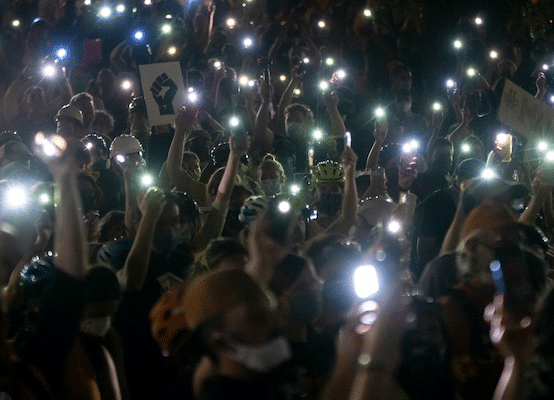 | Protesters hold their cellphones in the air during a Black Lives Matter event in front of the Multnomah County Justice Center on July 20 2020 in Portland Ore Photo Nathan HowardGetty Images | MR Online