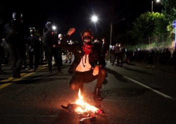 | A demonstrator in Portland on the night of July 16 | MR Online