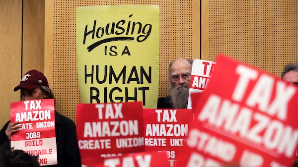 | Members of the public look on at a Seattle City Council before the council voted to approve a tax on large businesses such as Amazon and Starbucks to fight homelessness in Seattle Elaine Thompson | AP | MR Online