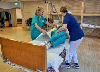 Laid-off flight attendants learn basic skills to work in nursing homes due to the coronavirus outbreak, in Stockholm. David Keyton | AP