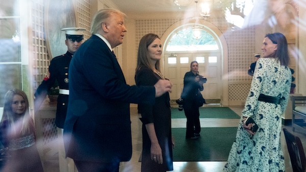 | In an image taken through a window President Donald Trump left and Judge Amy Coney Barrett walk through the Palm Room after announcing Barrett as his nominee to the Supreme Court in the Rose Garden at the White House Saturday Sept 26 2020 in Washington Alex Brandon | AP | MR Online