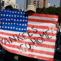 A protester carries a sign reading “Yankees go home!” during a rally protesting the 2018 G20 summit in Buenos Aires, Argentina. (Montecruz Foto)