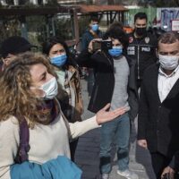 A supporter of Bogazici University students talks to police officers outside a courthouse in Istanbul, Thursday, Feb. 11 2021