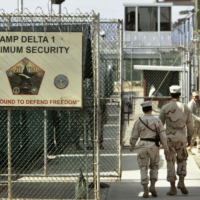 A photo reviewed by a military official before being made public shows U.S. military guards walking within the Camp Delta military-run prison in Guantanamo Bay, Cuba. AP Photo/Brennan Linsley