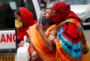 | A woman is consoled after her husband died due to the coronavirus disease COVID19 outside the mortuary of a COVID19 hospital in Ahmedabad India April 20 2021 | MR Online