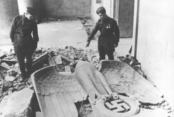 By April 1945, troops of the anti-Hitler coalition had liberated most of the territories occupied by the fascist Wehrmacht. The Red Army opened its offensive on the capital of the German Reich and the fierce ‘Battle of Berlin’ ended with the complete military defeat of Nazi Germany. This photograph shows two Red Army soldiers in the Reich Chancellery, Hitler’s last command post. At their feet lies the toppled symbol of fascist power, the imperial eagle above the swastika.