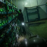 A worker checks the equipment inside a bitcoin mine in rural Sichuan province, 2016. Liu Xingzhe/People Visual