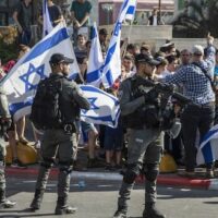 ISRAELI PARAMILITARY BORDER POLICE OFFICERS STAND GUARD AS JEWISH RIGHT-WING DEMONSTRATORS DEMAND THE RELEASE OF THREE JEWS ARRESTED IN THE SHOOTING DEATH OF MOUSA HASOONA, OUTSIDE THE DISTRICT COURT IN LOD, ISRAEL, WEDNESDAY, MAY 12, 2021. (AP PHOTO/HEIDI LEVINE)