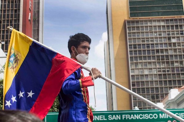 | Protester at a rally calling for jailed workers to be released in Caracas on June 22 Photo SurgentesFB | MR Online