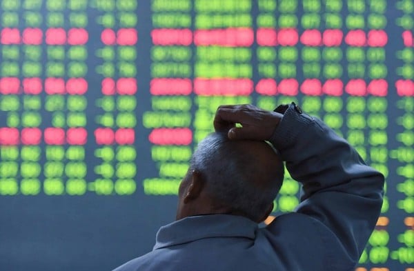 | An investor looks on as prices fall at a stock brokerage house in Hangzhou China Photo Canadian Dimension Shutterstock | MR Online