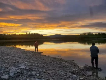 Where residents usually fish with nets to catch fish in quantities, a couple uses rods and reels to harvest non-salmon species at the mouth of the Melozi River, a tributary on the Yukon river. 