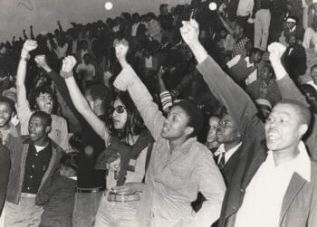 Vino Reddy (née Pillay) in dark glasses during the Viva FRELIMO rally, photograph taken outside of the Curries Fountain Stadium in Durban, 25 September 1974.