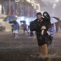 People walk through flooded streets in New York as the remnants of Hurricane Ida hit the city on the night of 1 September