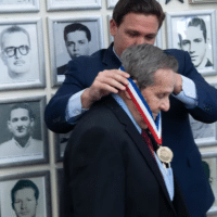 Florida Governor Ron DeSantis pinning medal on CIA assassin Félix Rodríguez on September 16, 2021. [Source: flgov.com]