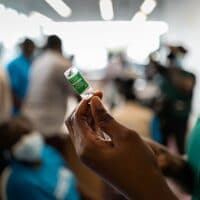 COVAX rollout: COVID-19 vaccinations begin in Ghana - nurse prepares vaccine.