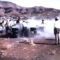 Workers shovel raw blue asbestos tailings into drums at an asbestos shovelling competition at Wittenoom in 1962.