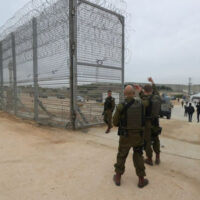 ISRAELI SECURITY PERSONNEL GESTURE AT AN OPENING TO THE NEWLY COMPLETED UNDERGROUND BARRIER ALONG ISRAEL’S FRONTIER WITH THE GAZA STRIP IN EREZ, SOUTHERN ISRAEL DECEMBER 7, 2021.