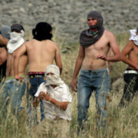 ISRAELI SETTLERS FROM THE JEWISH SETTLEMENT OF YITZHAR THROW STONES DURING CLASHES WITH PALESTINIANS FROM THE VILLAGE OF ASIRA AL-QIBILIYA, SOUTH OF THE NORTHERN WEST BANK CITY OF NABLUS ON MAY 19, 2012. (PHOTO: WAGDI ESHTAYAH/APA IMAGES)