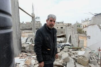 THE OWNER OF A HOME DESTROYED BY AN ISRAELI AIRSTRIKE IN MAY 2021 STANDS IN THEIR HOME IN BEIT HANOUN IN THE NORTHERN OF GAZA STRIP ON DECEMBER 9, 2021. OWNERS OF HOUSES PARTIALLY OR TOTALLY DESTROYED DURING THE MAY WAR ON GAZA ARE GROWING CONCERNED ABOUT THE DELAYED RECONSTRUCTION.