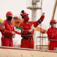 Workers of the state-oil company Pdvsa holding Iranian and Venezuelan flags greet during the arrival of the Iranian tanker ship "Fortune" at El Palito refinery in Puerto Cabello, Venezuela May 25, 2020. (Photo by Reuters)