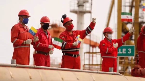 MR Online | Workers of the stateoil company Pdvsa holding Iranian and Venezuelan flags greet during the arrival of the Iranian tanker ship Fortune at El Palito refinery in Puerto Cabello Venezuela May 25 2020 Photo by Reuters | MR Online