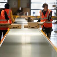 Not everyone smiling—Amazon workers at Vélizy-Villacoublay in France (Frederic Legrand—COMEO / shutterstock.com)