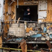 | photo | A man inspects the damage at a building in Kiev Ukraine Feb 25 2022 Emilio Morenatti | AP | MR Online