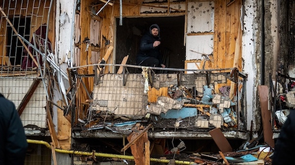 | photo | A man inspects the damage at a building in Kiev Ukraine Feb 25 2022 Emilio Morenatti | AP | MR Online